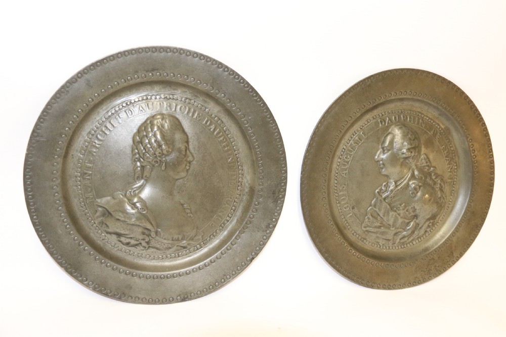 A pair of round silver grey pewter plates featuring raised profile relief portraits of Marie Antoinette and Louis XVI with beaded outer borders. View VIII
