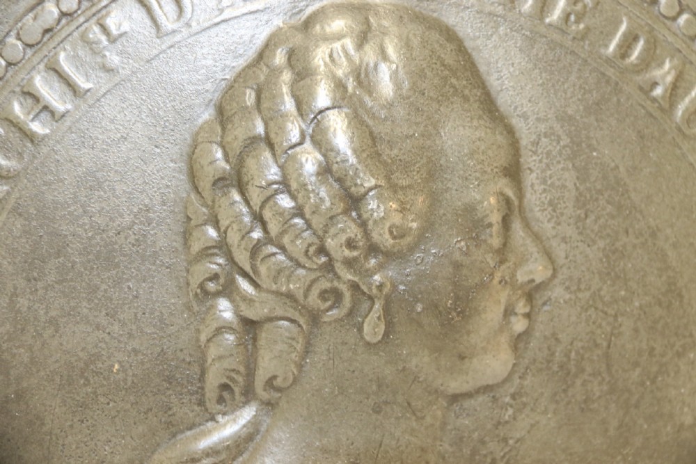 A pair of round silver grey pewter plates featuring raised profile relief portraits of Marie Antoinette and Louis XVI with beaded outer borders. View IX