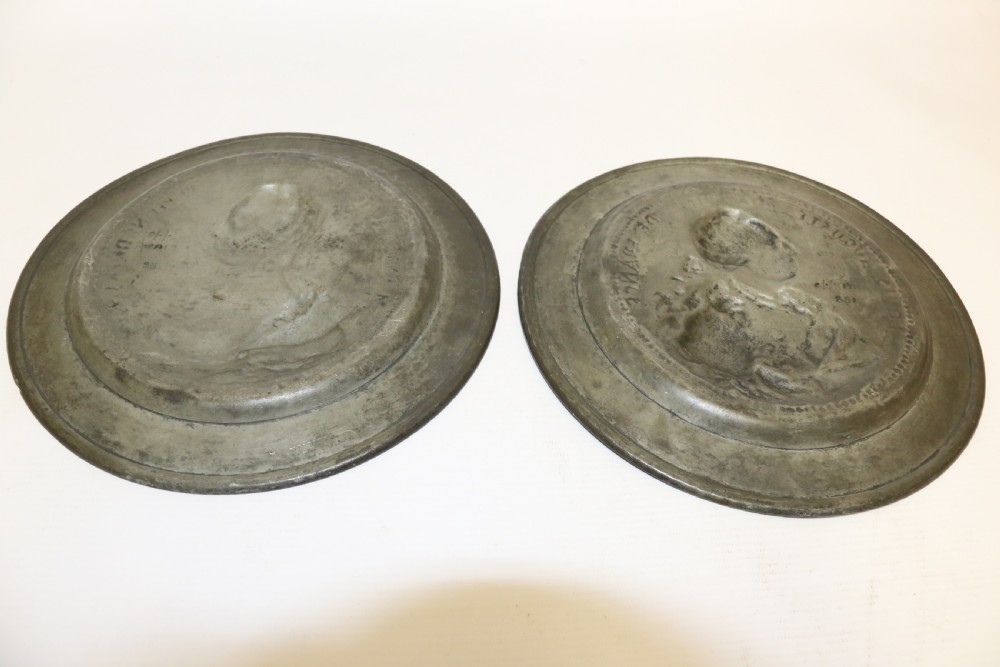 A pair of round silver grey pewter plates featuring raised profile relief portraits of Marie Antoinette and Louis XVI with beaded outer borders. View XIII