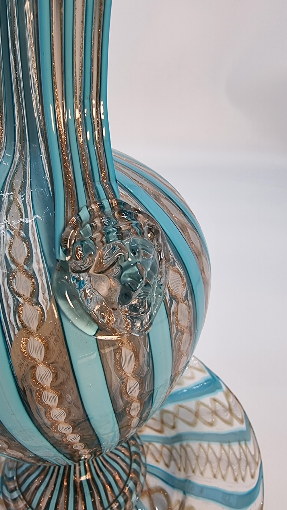 An antique Venetian glass claret set featuring a striped turquoise blue and white latticinio ewer with handle, matching saucer, and two stemware goblets. View XIV