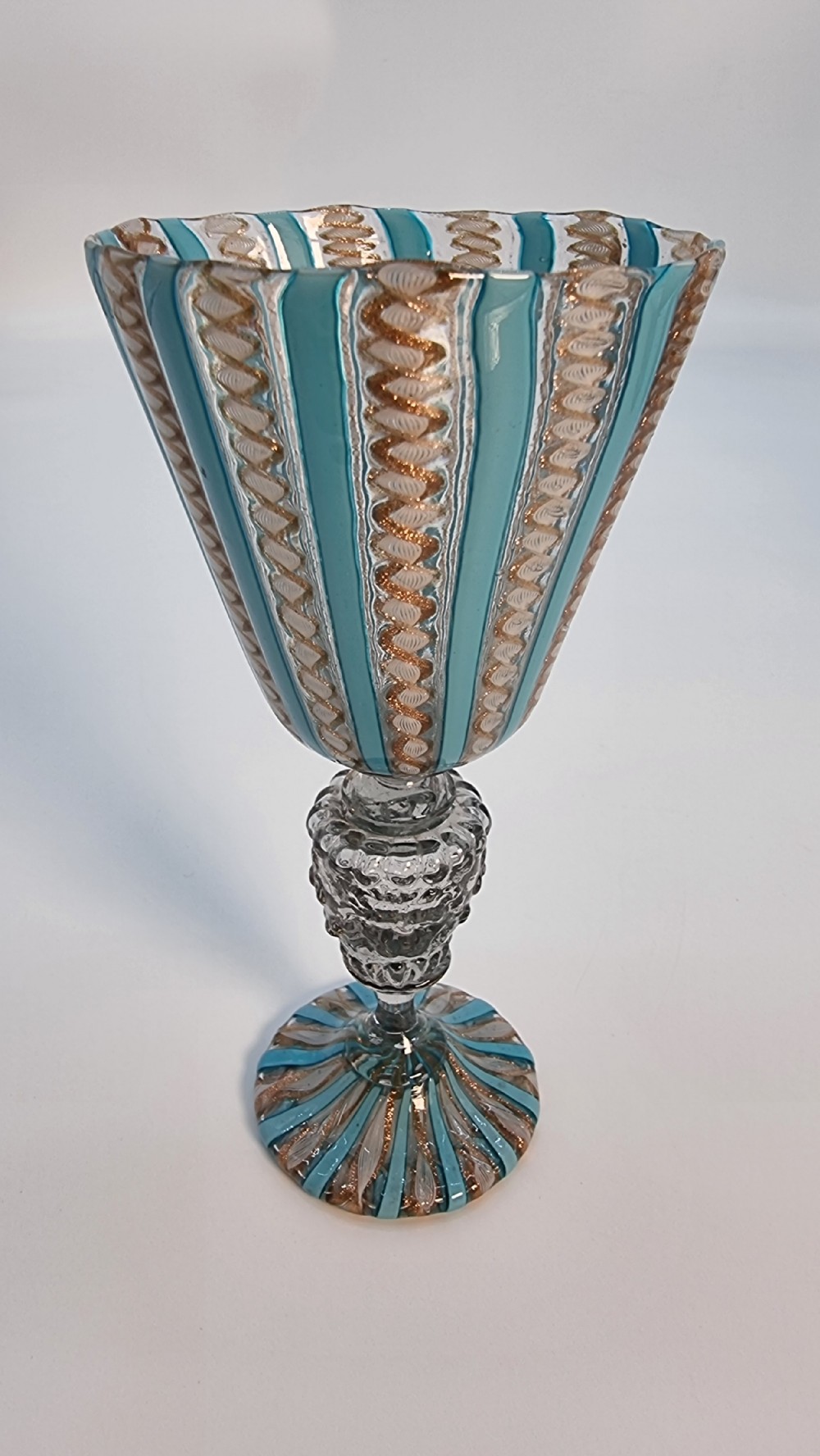 An antique Venetian glass claret set featuring a striped turquoise blue and white latticinio ewer with handle, matching saucer, and two stemware goblets. View XX