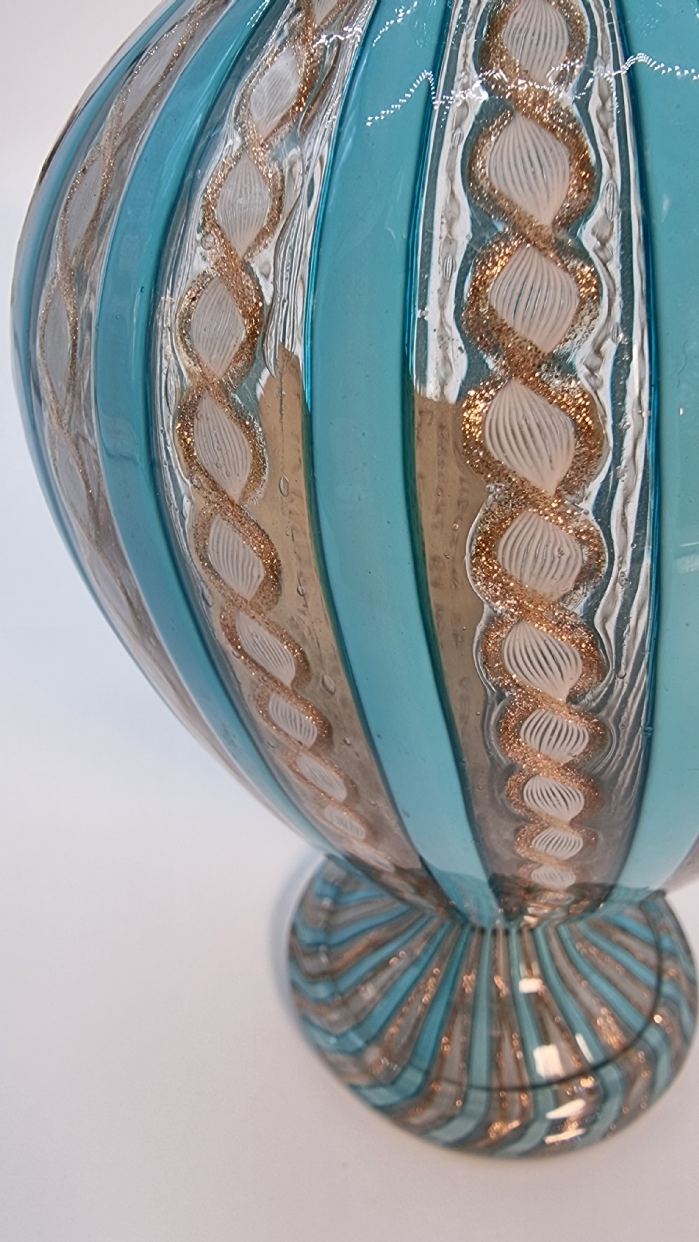 An antique Venetian glass claret set featuring a striped turquoise blue and white latticinio ewer with handle, matching saucer, and two stemware goblets. View XXIV