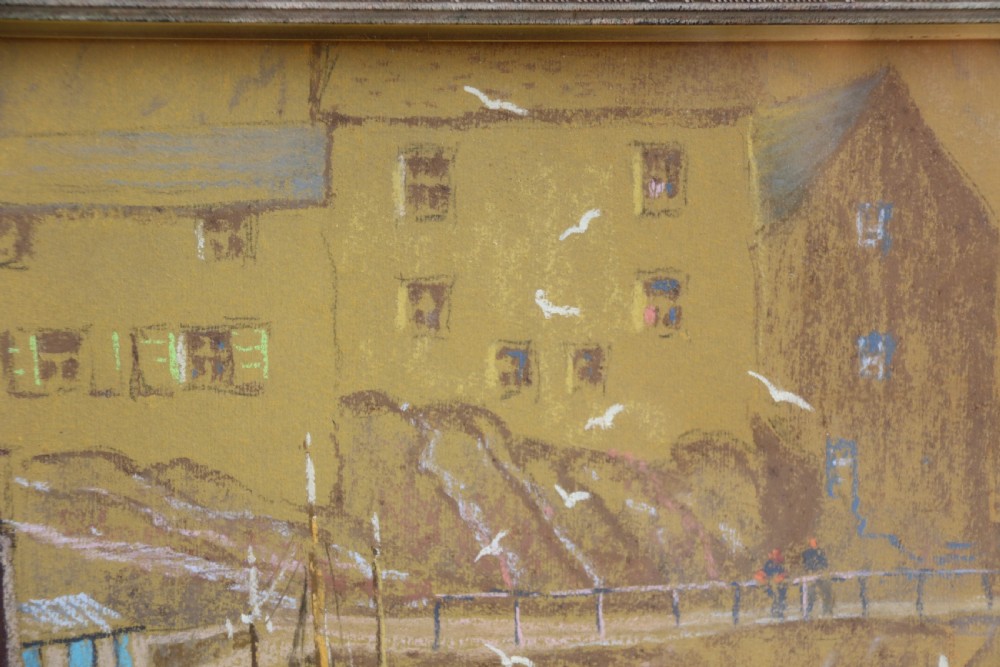 A framed pastel drawing depicting Polperro Harbour with fishing boats and stone cottages, set within an ornate swept frame. View V