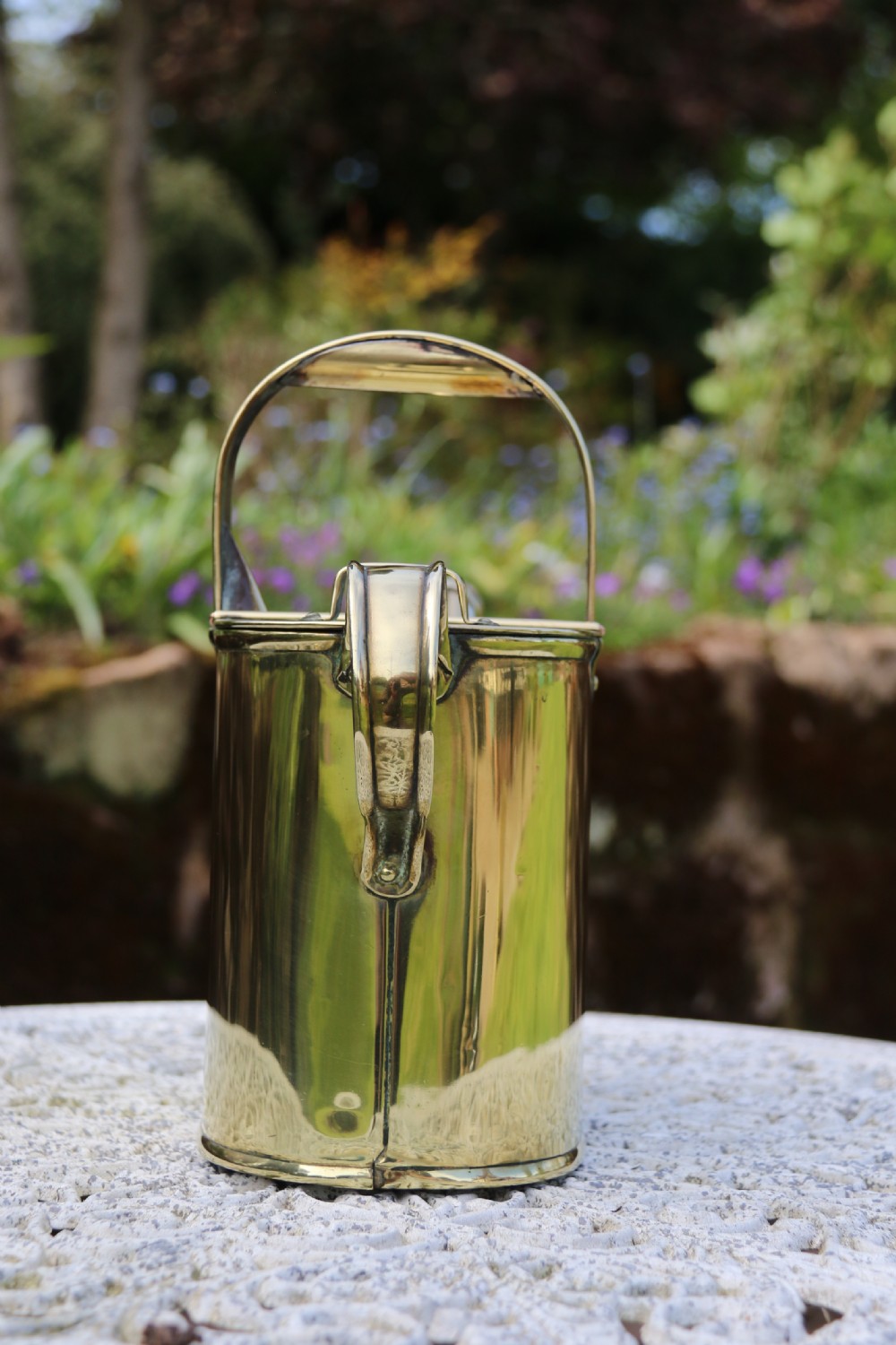 A pair of polished 19th-century brass watering cans in differing sizes featuring reeded cylindrical bodies, arched top handles, and angled spouts. View XIV