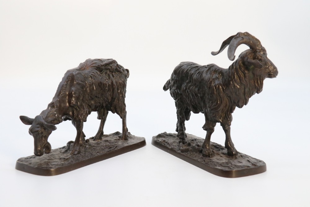 A pair of 19th-century French dark brown patinated bronze sculptures depicting a standing horned goat and a grazing goat on naturalistic bases. View III