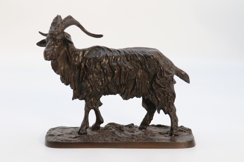 A pair of 19th-century French dark brown patinated bronze sculptures depicting a standing horned goat and a grazing goat on naturalistic bases. View VII