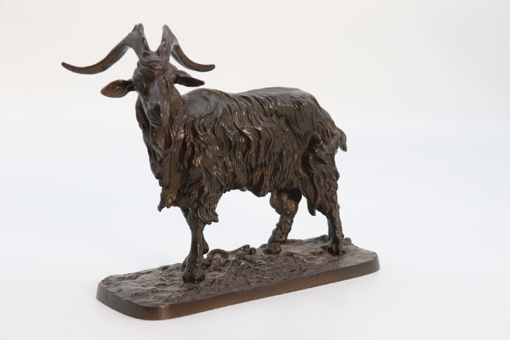 A pair of 19th-century French dark brown patinated bronze sculptures depicting a standing horned goat and a grazing goat on naturalistic bases. View VIII