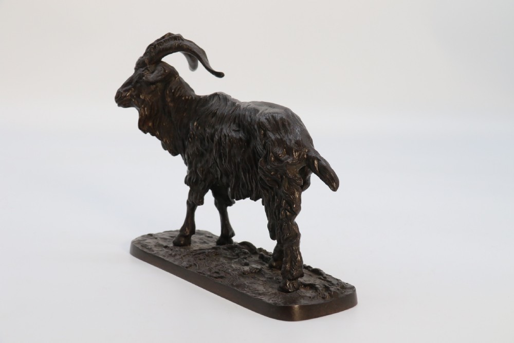 A pair of 19th-century French dark brown patinated bronze sculptures depicting a standing horned goat and a grazing goat on naturalistic bases. View IX