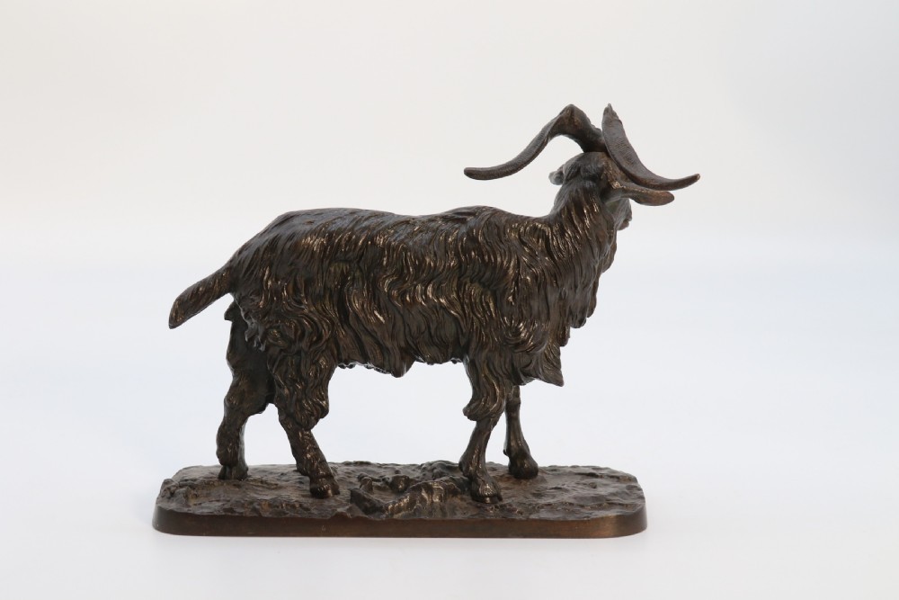 A pair of 19th-century French dark brown patinated bronze sculptures depicting a standing horned goat and a grazing goat on naturalistic bases. View XI