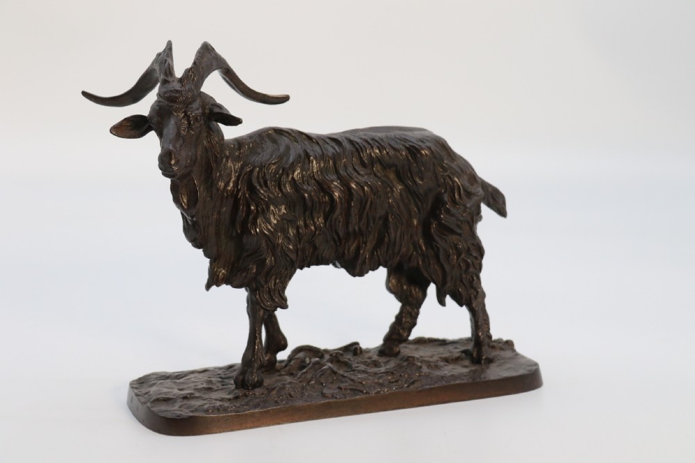 A pair of 19th-century French dark brown patinated bronze sculptures depicting a standing horned goat and a grazing goat on naturalistic bases. View XII