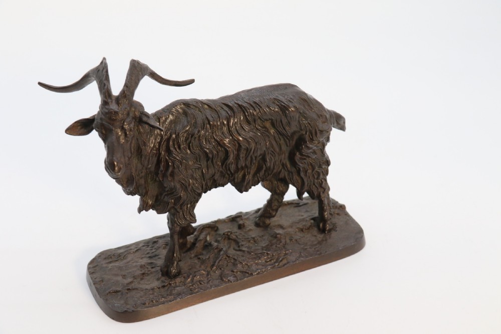 A pair of 19th-century French dark brown patinated bronze sculptures depicting a standing horned goat and a grazing goat on naturalistic bases. View XIII