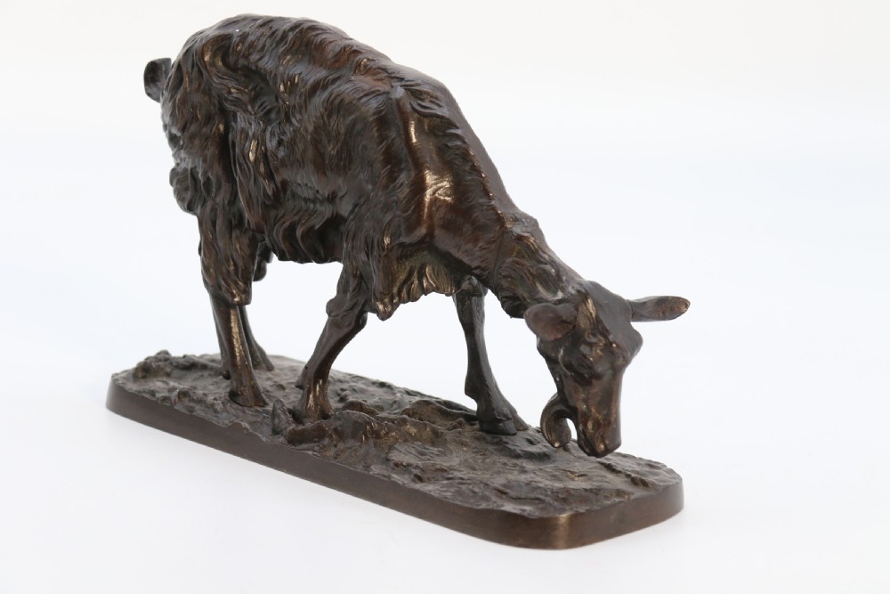 A pair of 19th-century French dark brown patinated bronze sculptures depicting a standing horned goat and a grazing goat on naturalistic bases. View XV