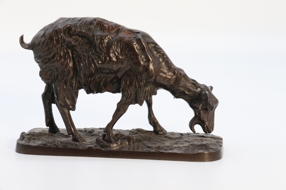 A pair of 19th-century French dark brown patinated bronze sculptures depicting a standing horned goat and a grazing goat on naturalistic bases. View XVI