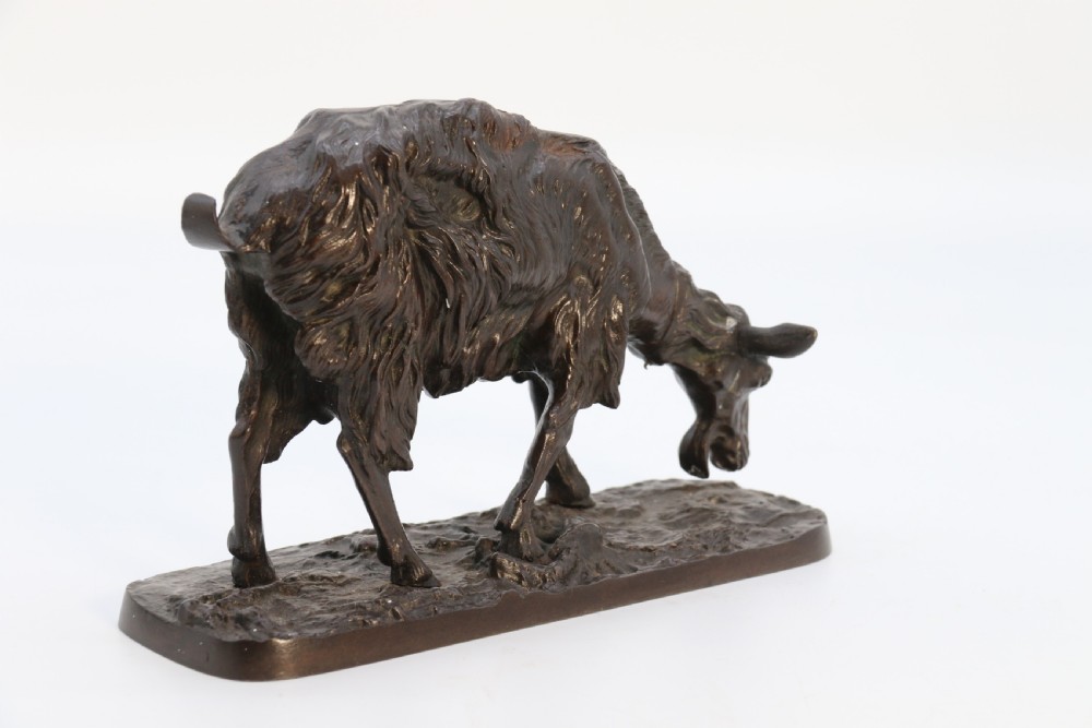 A pair of 19th-century French dark brown patinated bronze sculptures depicting a standing horned goat and a grazing goat on naturalistic bases. View XVII