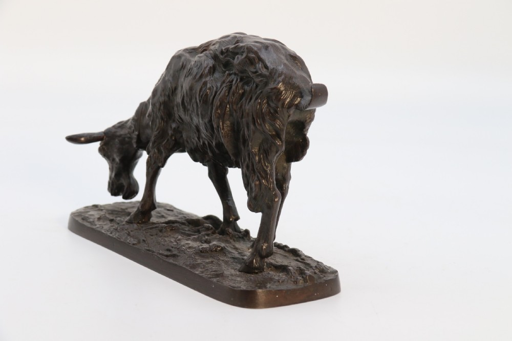 A pair of 19th-century French dark brown patinated bronze sculptures depicting a standing horned goat and a grazing goat on naturalistic bases. View XVIII