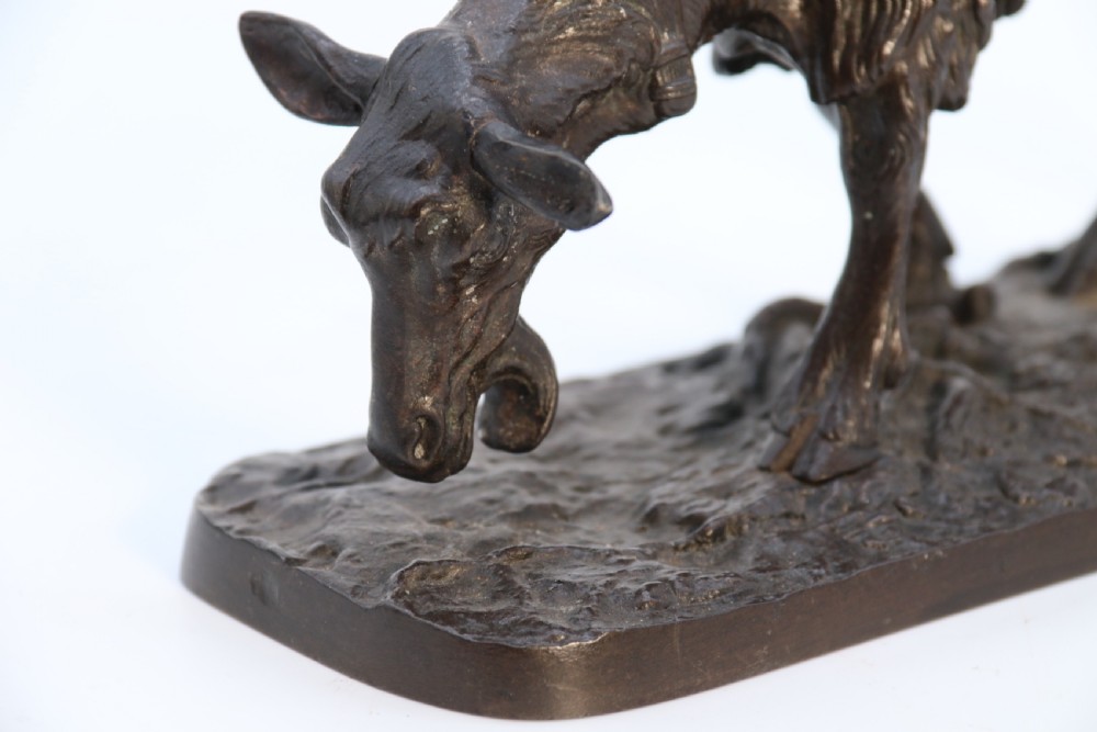 A pair of 19th-century French dark brown patinated bronze sculptures depicting a standing horned goat and a grazing goat on naturalistic bases. View XIX