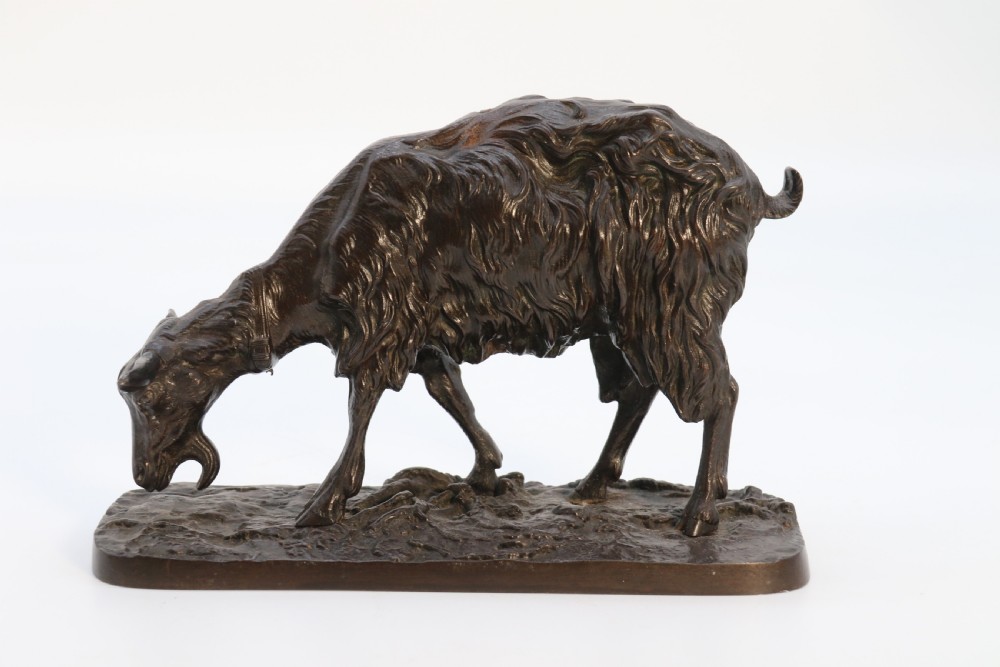 A pair of 19th-century French dark brown patinated bronze sculptures depicting a standing horned goat and a grazing goat on naturalistic bases. View XX