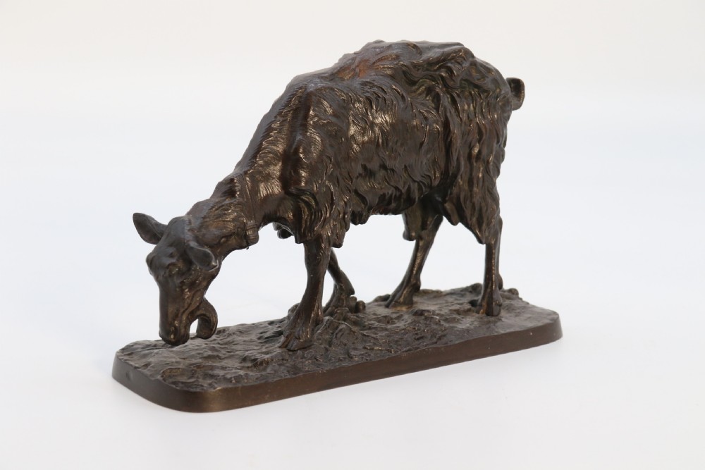 A pair of 19th-century French dark brown patinated bronze sculptures depicting a standing horned goat and a grazing goat on naturalistic bases. View XXI
