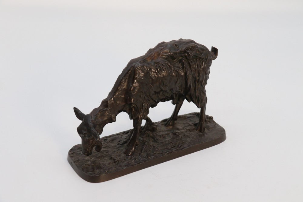 A pair of 19th-century French dark brown patinated bronze sculptures depicting a standing horned goat and a grazing goat on naturalistic bases. View XXII