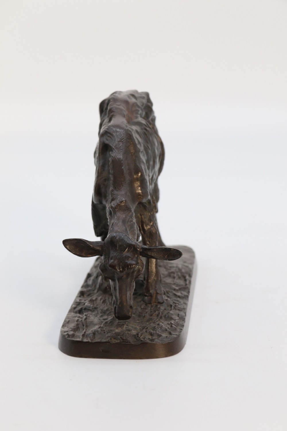 A pair of 19th-century French dark brown patinated bronze sculptures depicting a standing horned goat and a grazing goat on naturalistic bases. View XXV