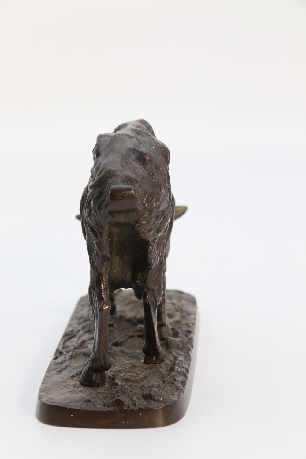 A pair of 19th-century French dark brown patinated bronze sculptures depicting a standing horned goat and a grazing goat on naturalistic bases. View XXVI