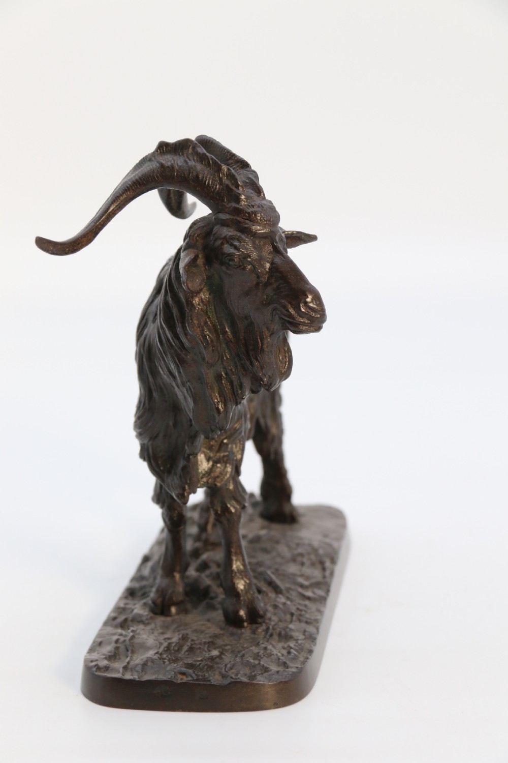 A pair of 19th-century French dark brown patinated bronze sculptures depicting a standing horned goat and a grazing goat on naturalistic bases. View XXIX