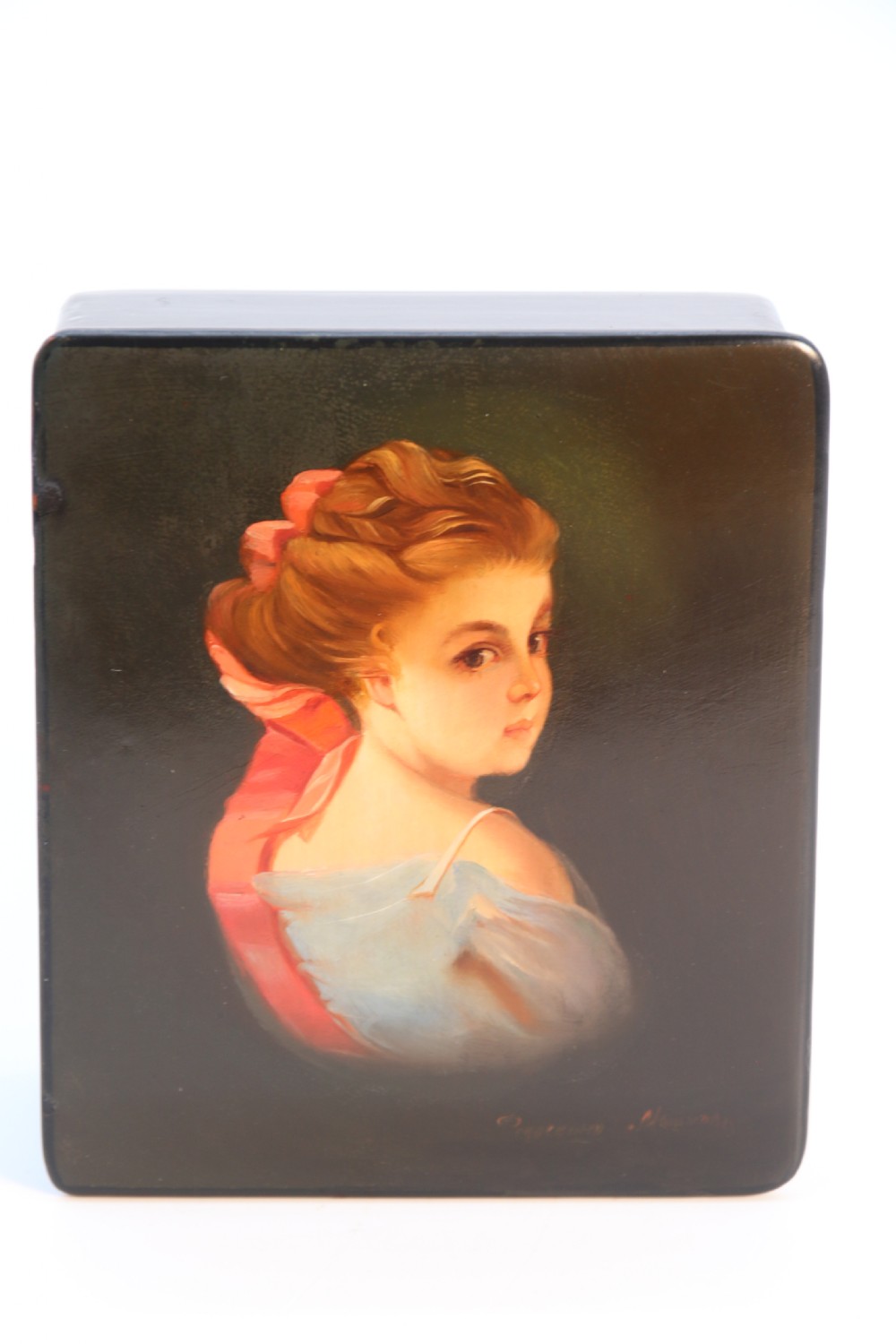 A square black lacquered box featuring a hand-painted portrait of a young woman with brown hair and a red ribbon. View XVI