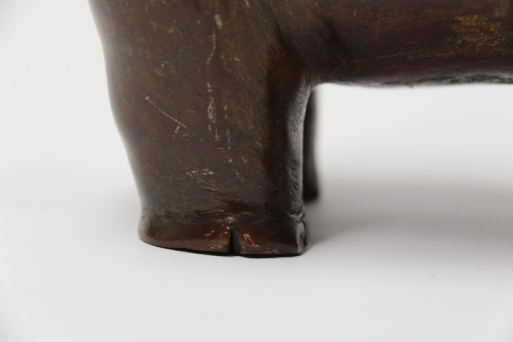 A dark brown carved hardwood hippopotamus sculpture with open mouth detailing inset bone teeth and carved body folds. View XIII
