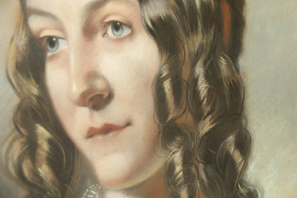 A mid-19th-century pastel portrait of a young woman with ringlets, presented in a rich burl wood frame with a gilt inner slip. View V