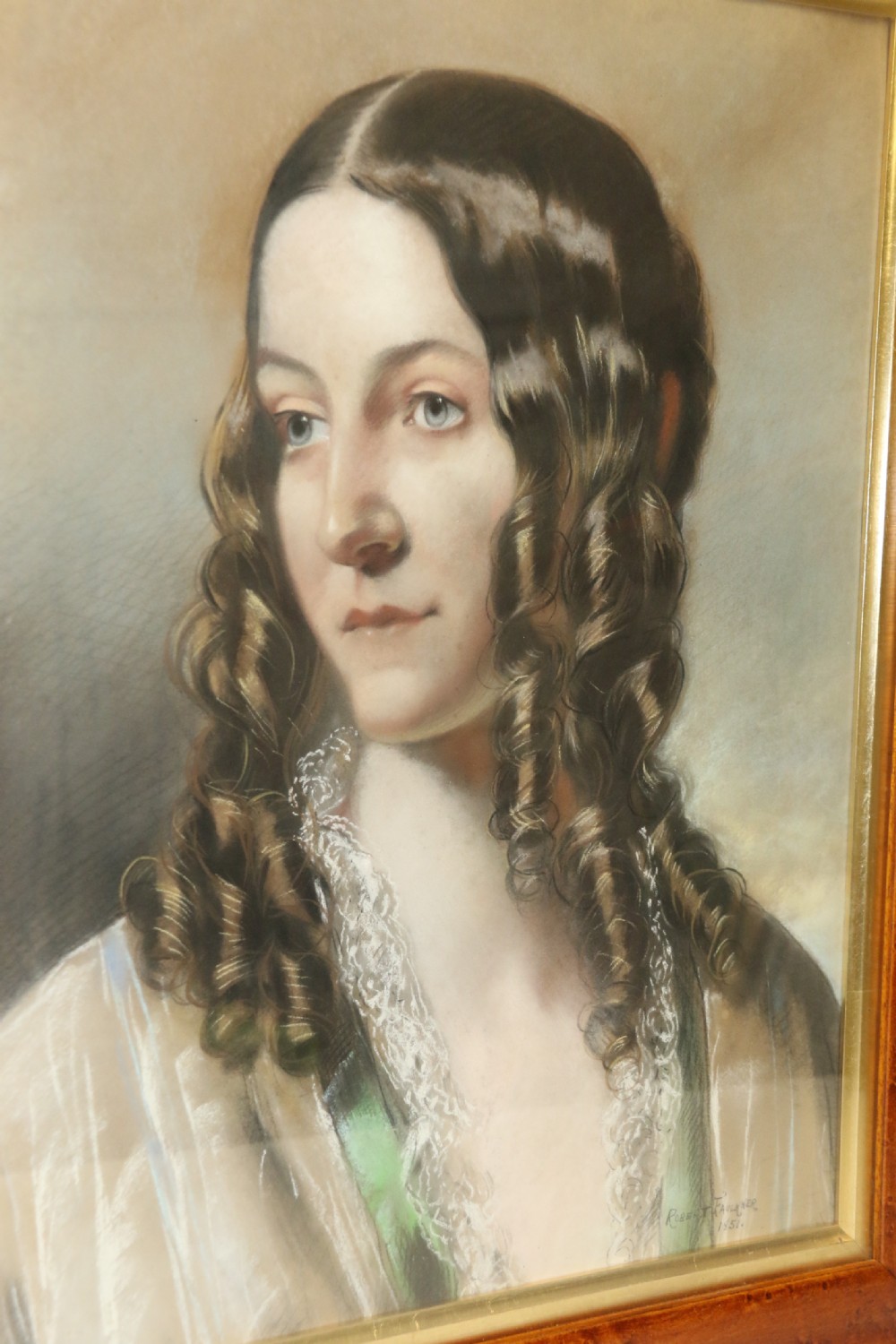A mid-19th-century pastel portrait of a young woman with ringlets, presented in a rich burl wood frame with a gilt inner slip. View IX