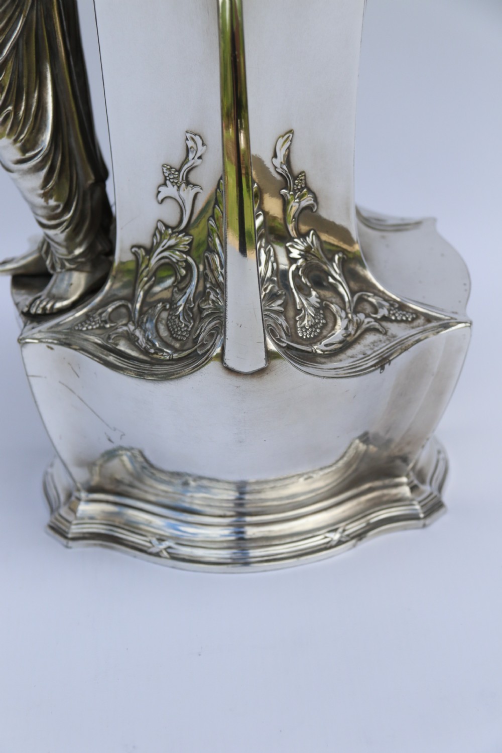 An Art Nouveau silver-plated WMF vase featuring a sculpted maiden figure in relief, sweeping organic handles, and a cut glass rim insert. View XI