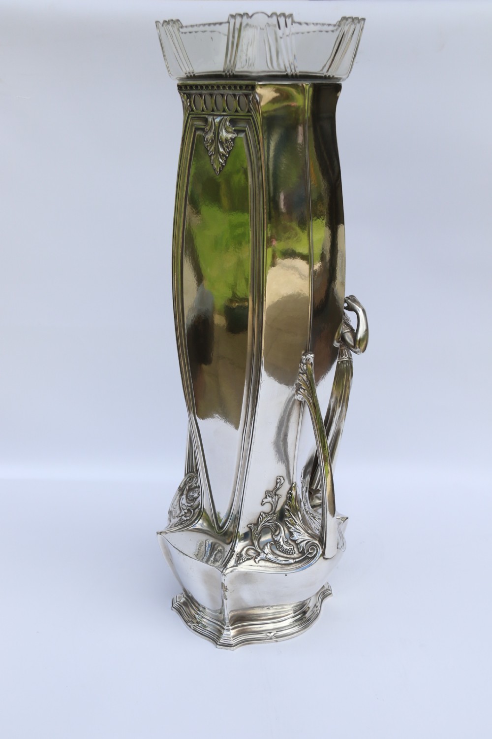 An Art Nouveau silver-plated WMF vase featuring a sculpted maiden figure in relief, sweeping organic handles, and a cut glass rim insert. View XVI