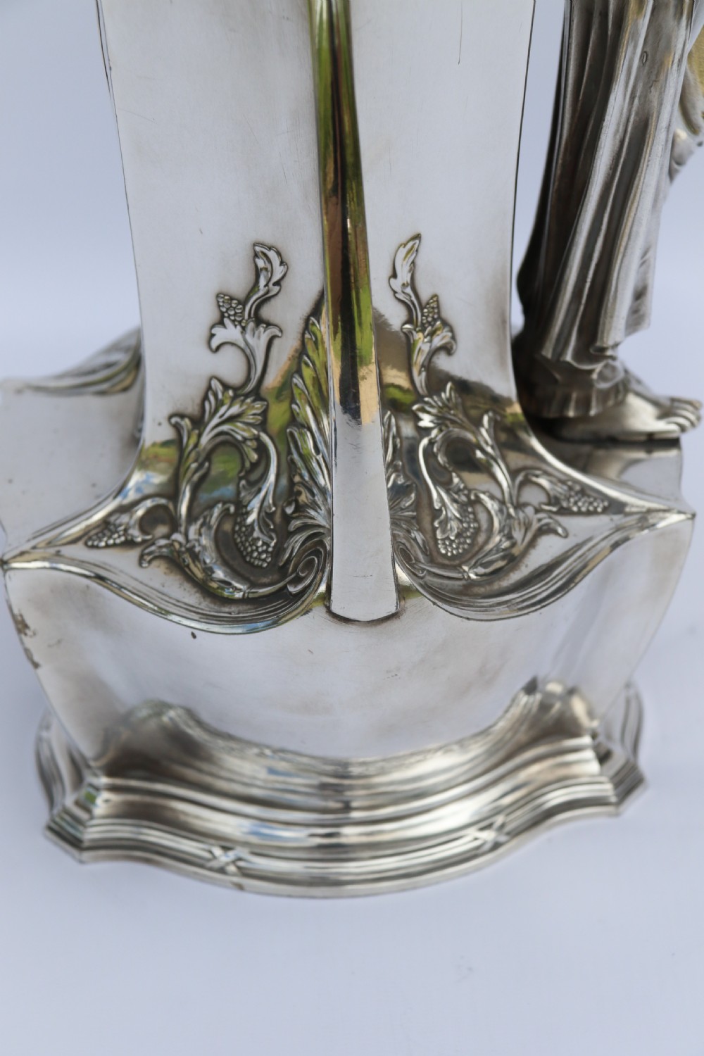 An Art Nouveau silver-plated WMF vase featuring a sculpted maiden figure in relief, sweeping organic handles, and a cut glass rim insert. View XVII