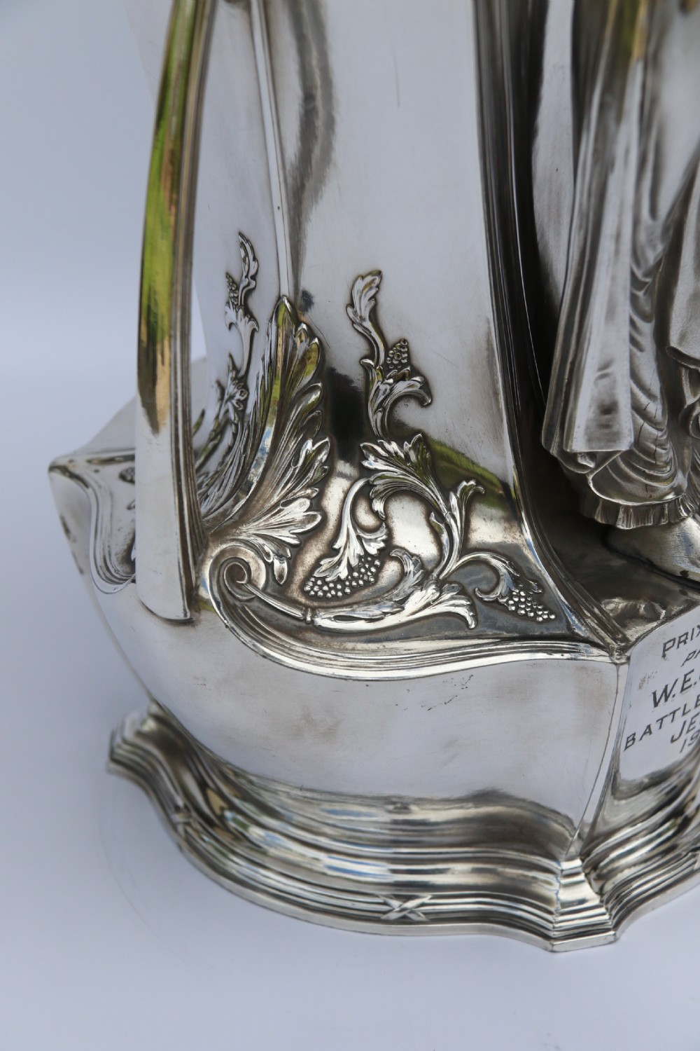 An Art Nouveau silver-plated WMF vase featuring a sculpted maiden figure in relief, sweeping organic handles, and a cut glass rim insert. View XVIII