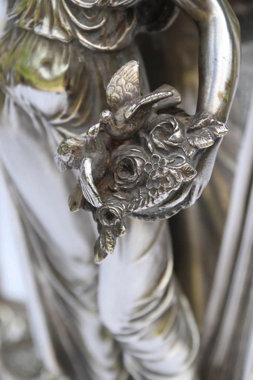 An Art Nouveau silver-plated WMF vase featuring a sculpted maiden figure in relief, sweeping organic handles, and a cut glass rim insert. View XX