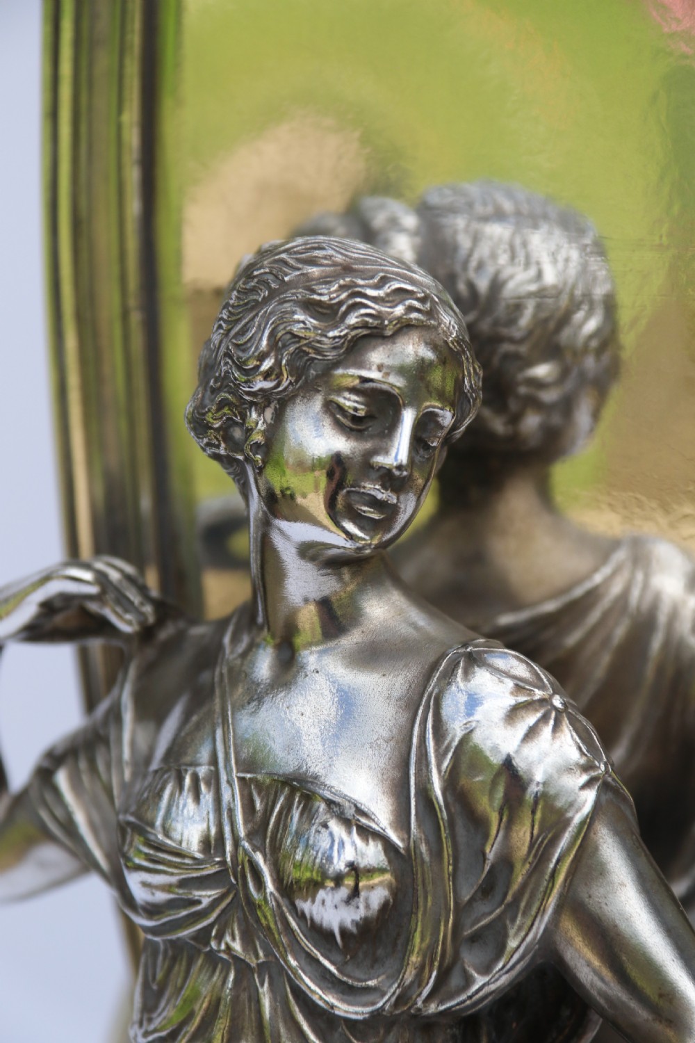 An Art Nouveau silver-plated WMF vase featuring a sculpted maiden figure in relief, sweeping organic handles, and a cut glass rim insert. View XXI