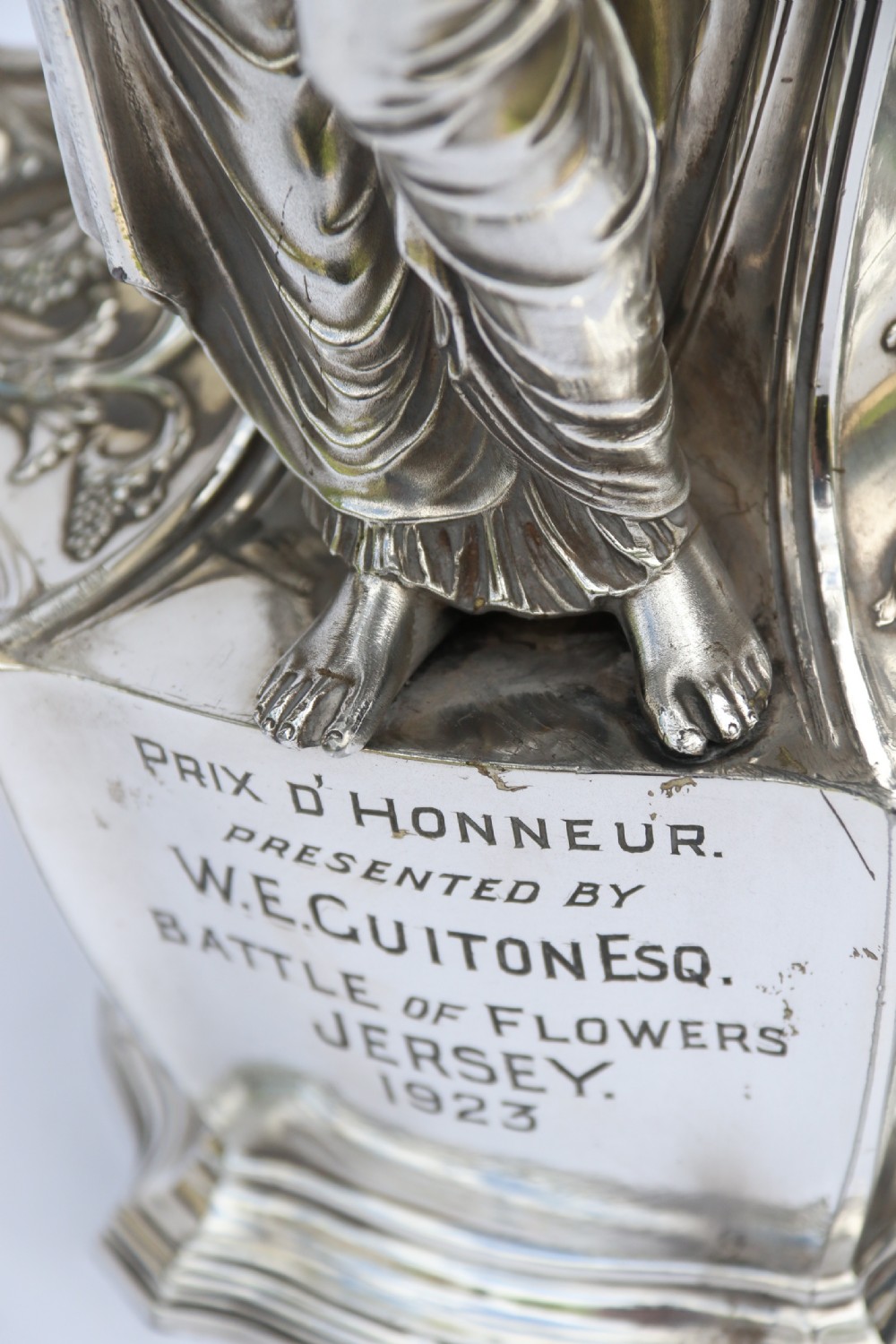 An Art Nouveau silver-plated WMF vase featuring a sculpted maiden figure in relief, sweeping organic handles, and a cut glass rim insert. View XXII