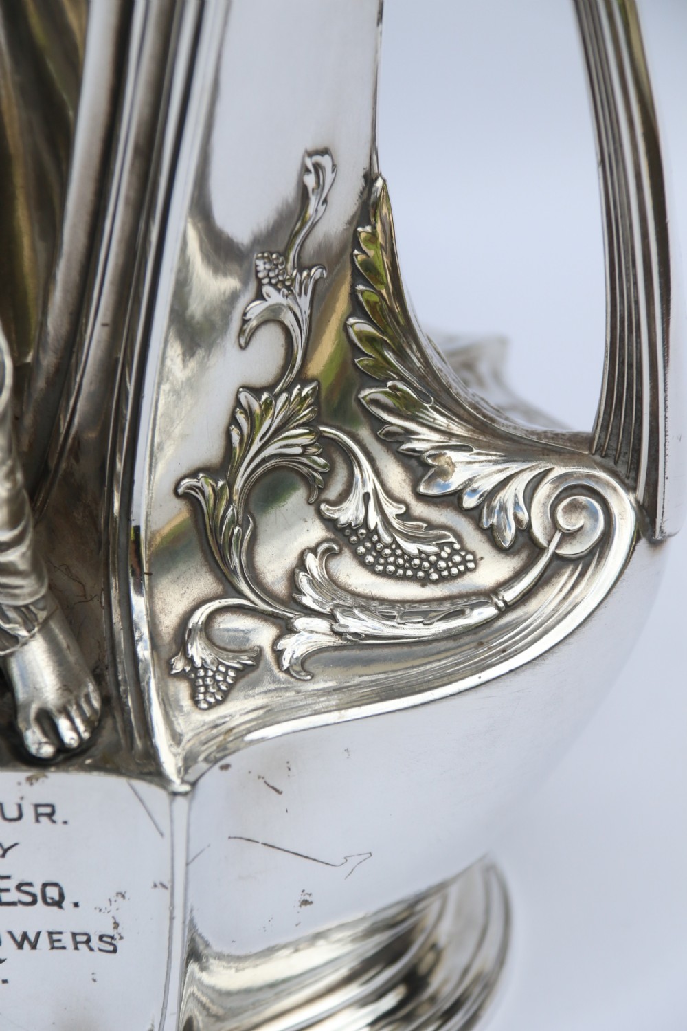 An Art Nouveau silver-plated WMF vase featuring a sculpted maiden figure in relief, sweeping organic handles, and a cut glass rim insert. View XXIII