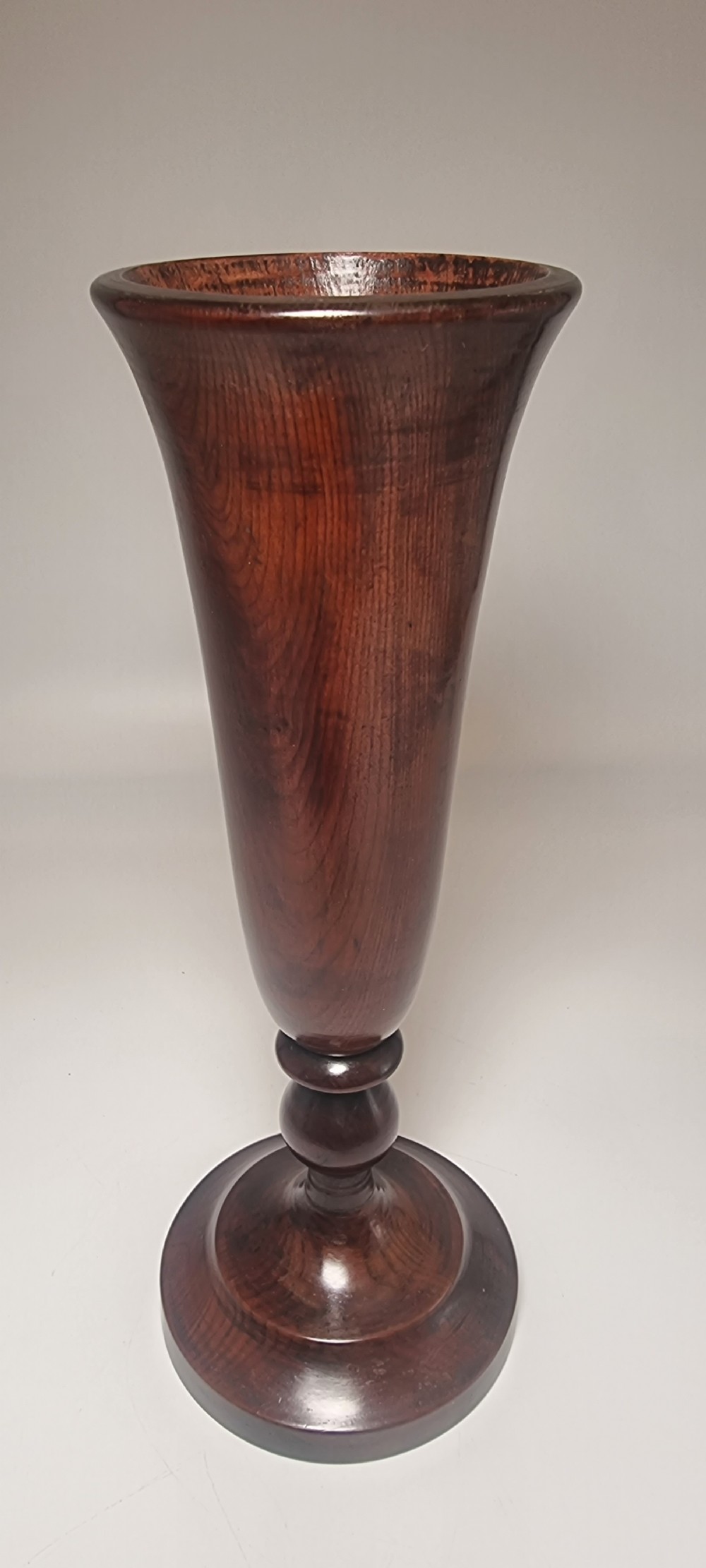A pair of turned 18th-century yew wood treen vases with flared rims, turned stems, and stepped circular bases. View XII