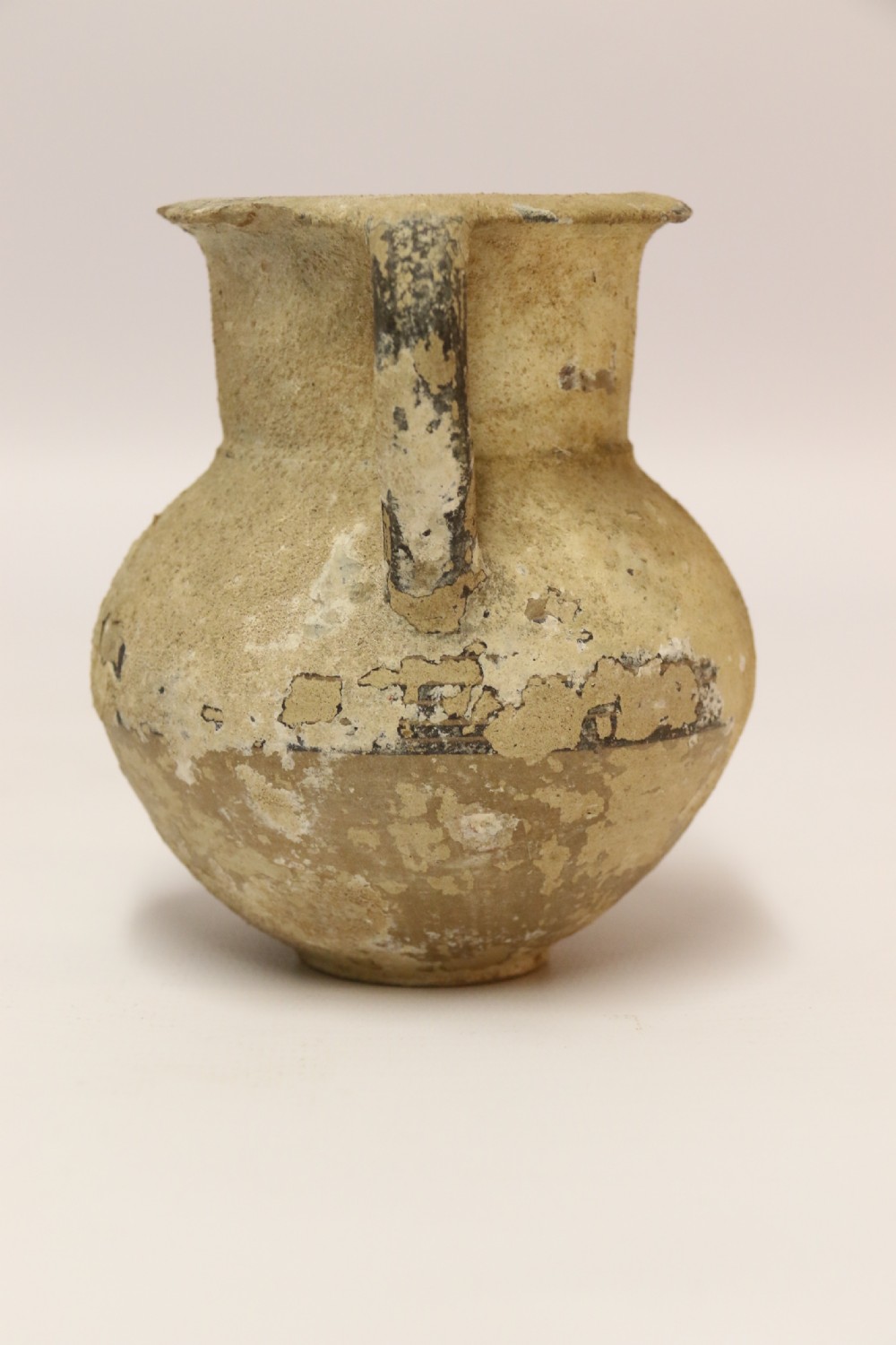 A collection of three unglazed ancient Greek terracotta vessels including a double-handled jar, a small pitcher, and a flattened flask. View VI