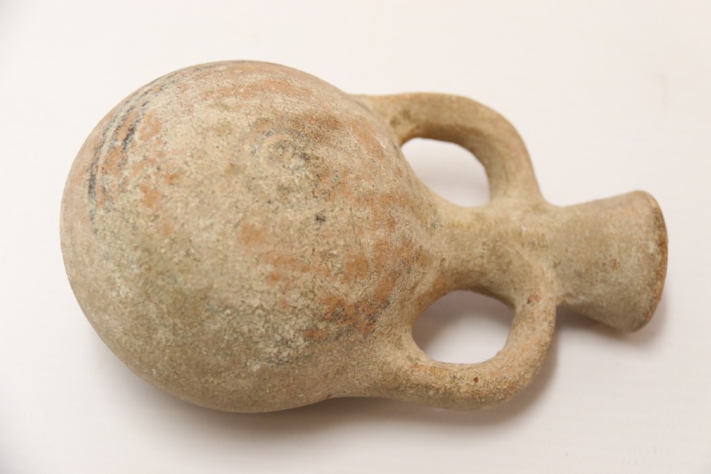 A collection of three unglazed ancient Greek terracotta vessels including a double-handled jar, a small pitcher, and a flattened flask. View VIII