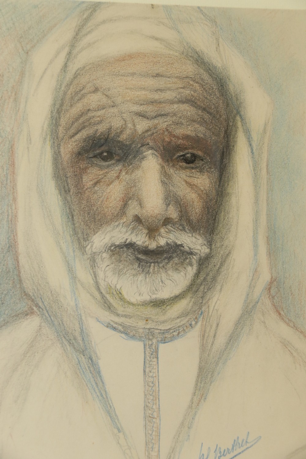 A framed late 19th-century portrait drawing on cream paper depicting an elderly Arabian man wearing a white hooded tunic. View IV