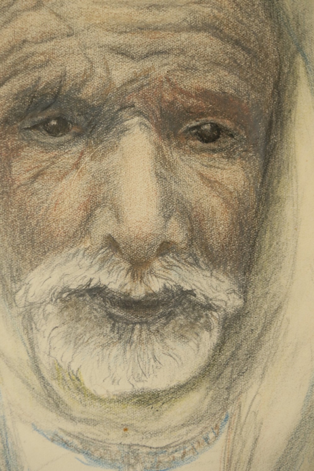 A framed late 19th-century portrait drawing on cream paper depicting an elderly Arabian man wearing a white hooded tunic. View V
