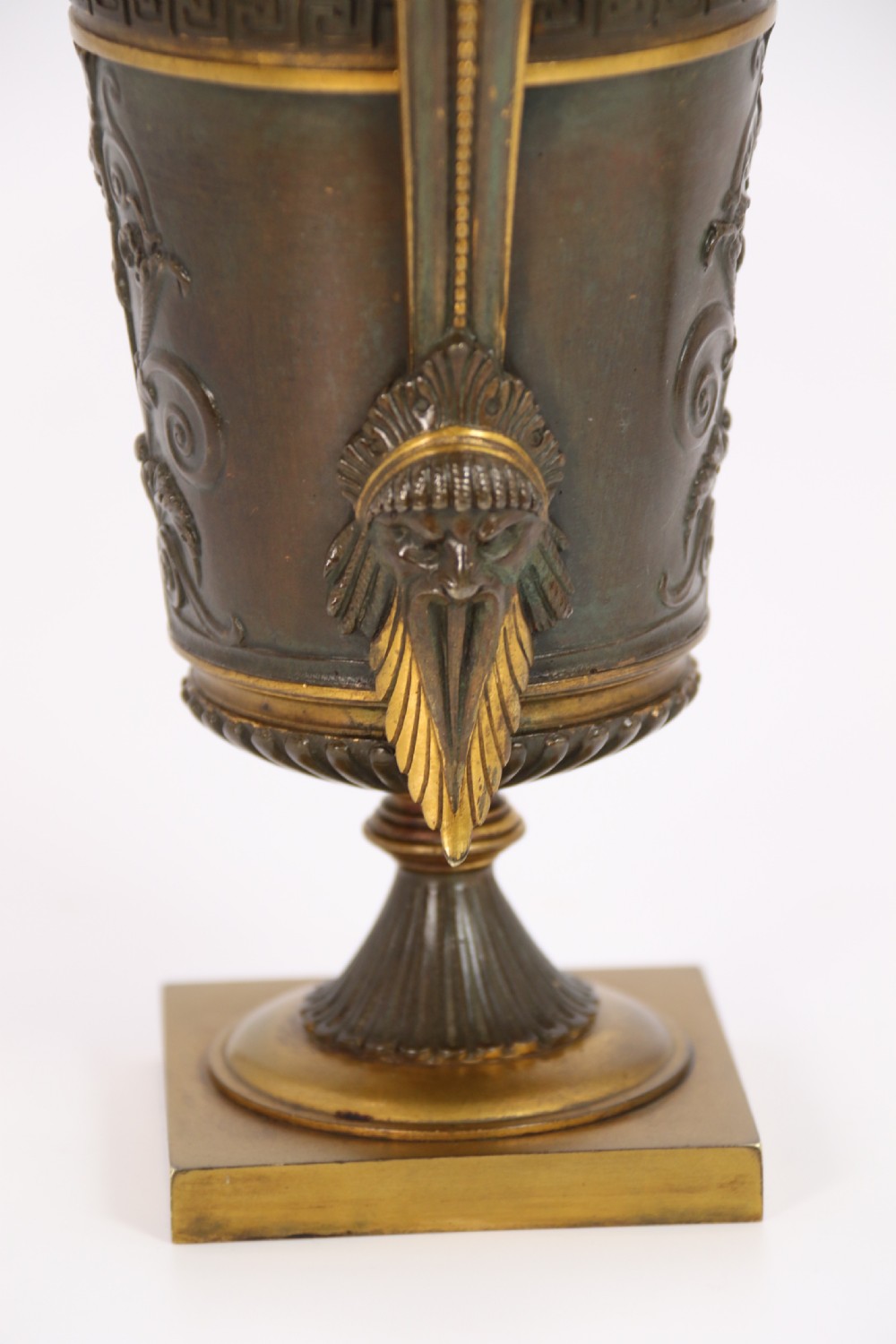 A pair of French Empire patinated and gilt bronze urns with Greek key friezes, scroll handles, and square bases. View XIII