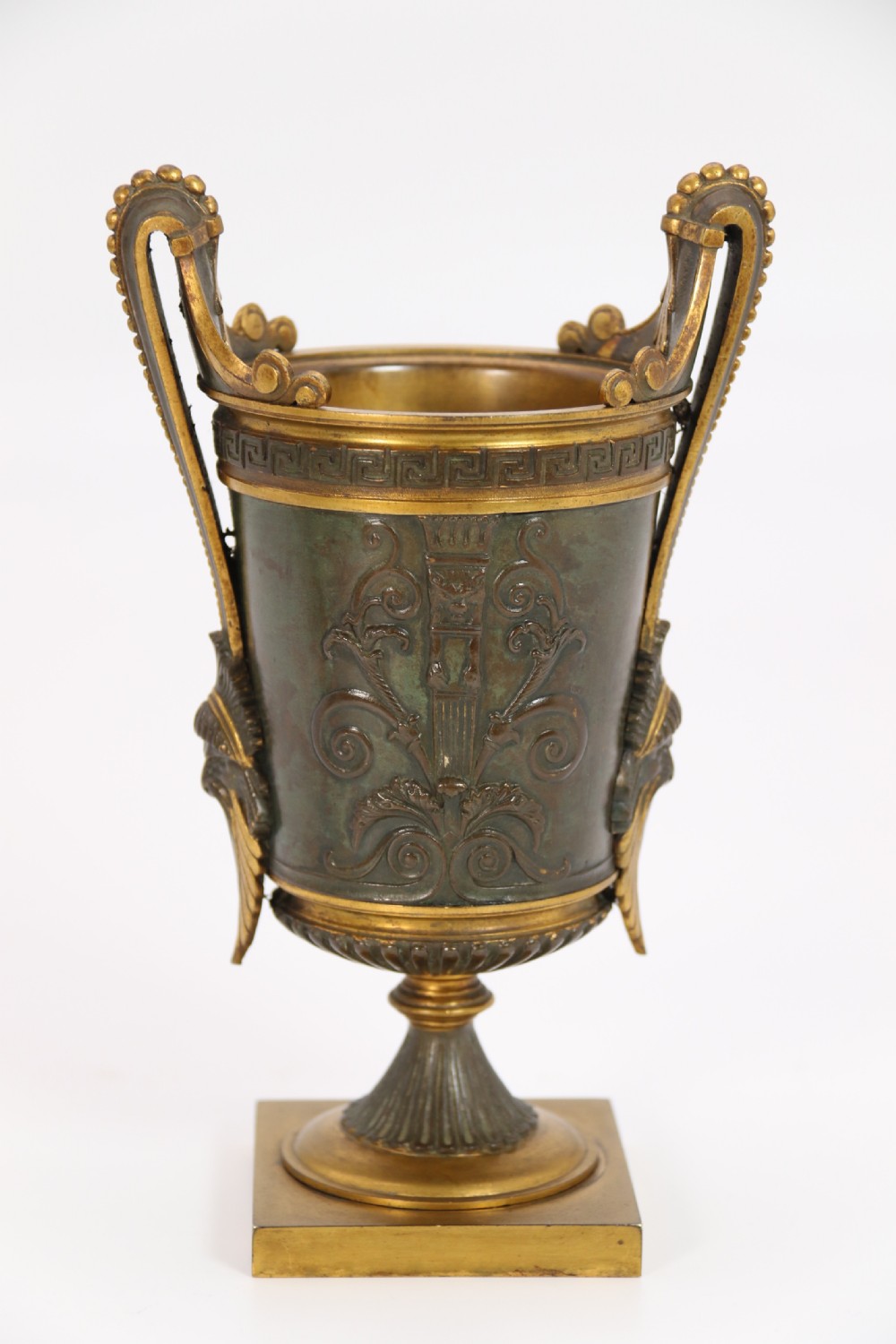 A pair of French Empire patinated and gilt bronze urns with Greek key friezes, scroll handles, and square bases. View XV