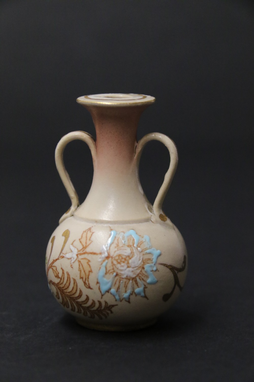 A set of three antique miniature cream ceramic vases featuring hand-painted floral motifs in blue, green, and brown with gilded highlights. View XII