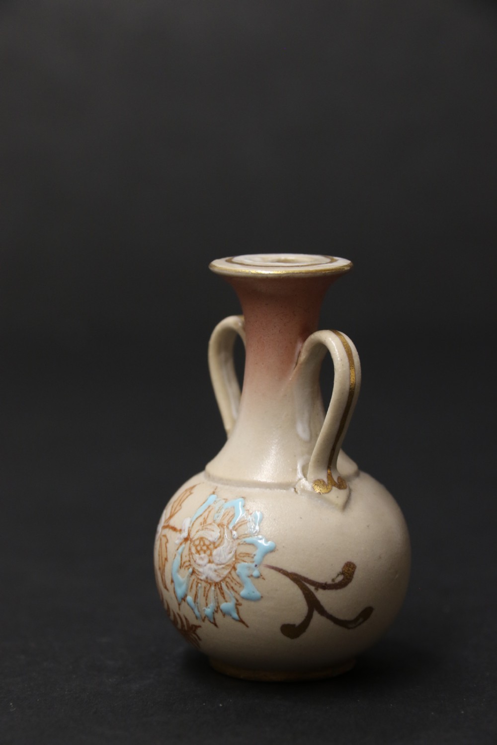 A set of three antique miniature cream ceramic vases featuring hand-painted floral motifs in blue, green, and brown with gilded highlights. View XIII