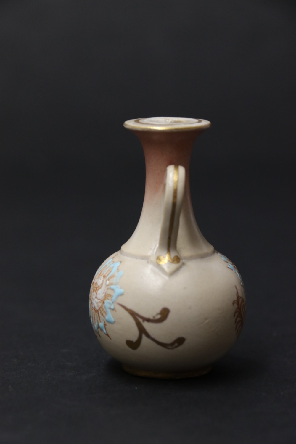 A set of three antique miniature cream ceramic vases featuring hand-painted floral motifs in blue, green, and brown with gilded highlights. View XIV