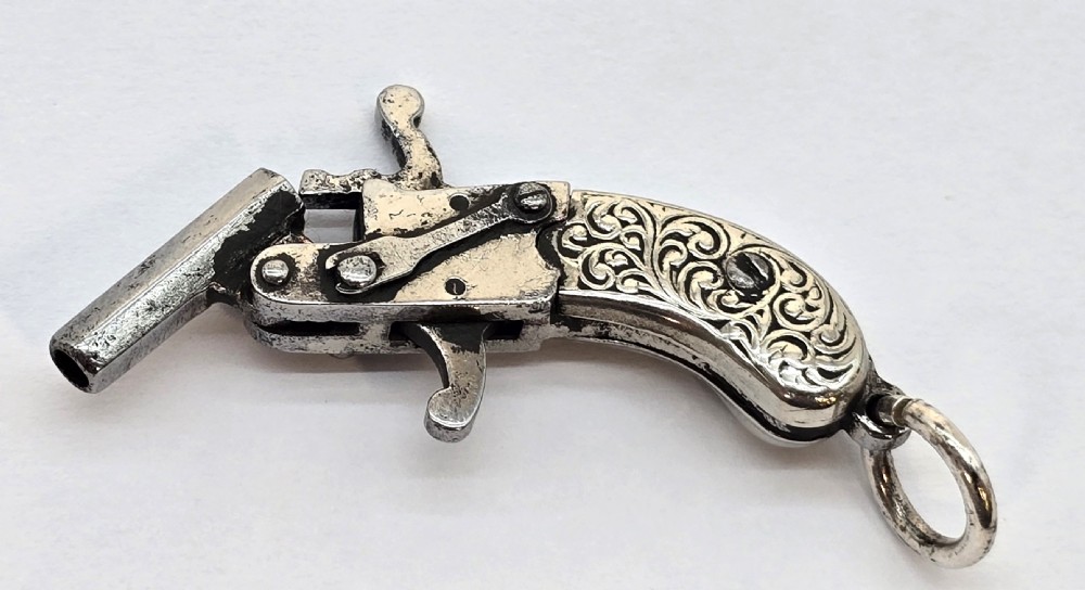 A superb pocket watch chain fob in the form of a flintlock pistol

 View V