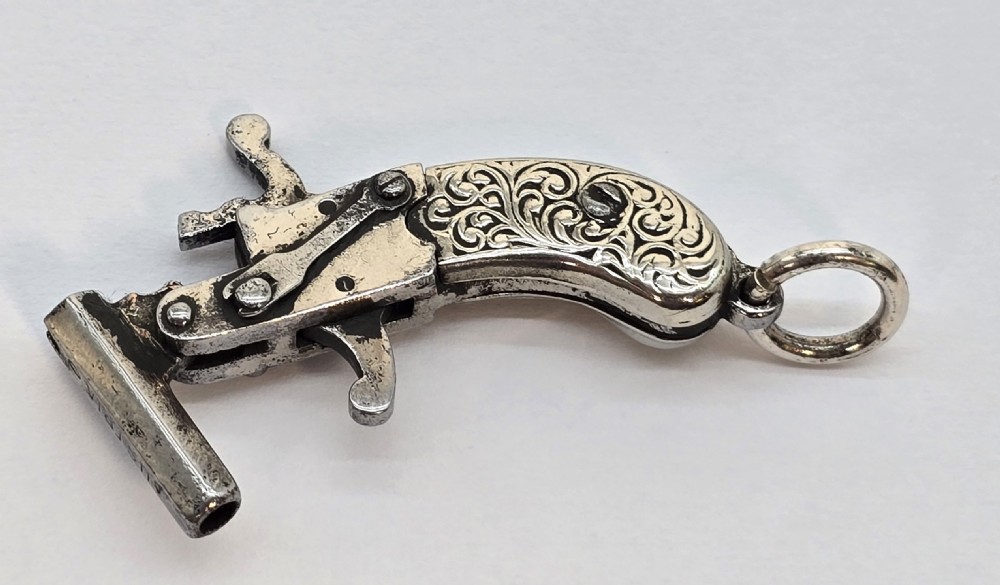 A superb pocket watch chain fob in the form of a flintlock pistol

 View VII